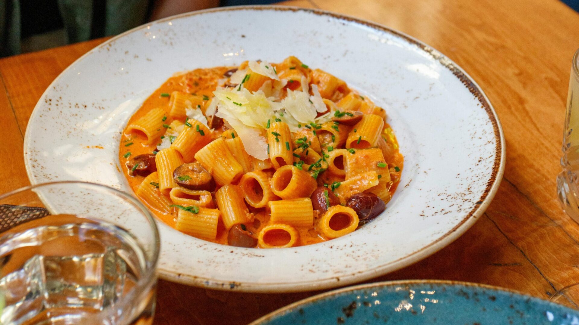 Plate of creamy ditalini pasta served with a rich tomato-based sauce, garnished with grated cheese and fresh herbs, ideal for easy recipes with ditalini pasta.