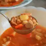 Crockpot Soup Recipes: Easy, Hearty & Delicious Meals for Every Season 7 Ladle filled with beef, potatoes, and vegetables from one of the best crockpot soup recipes.